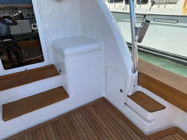 Quite Nice Yacht Photos Pics 2004 Bertram 570 Convertible yacht interior with teak steps and seating area.