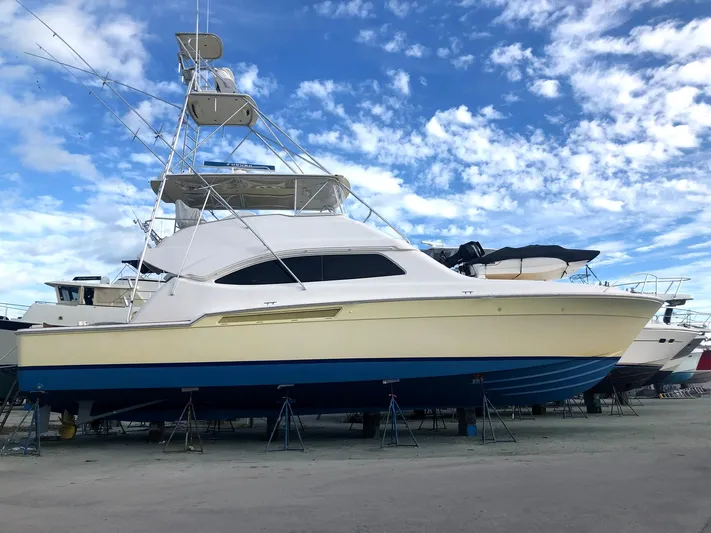 Quite Nice Yacht Photos Pics 2004 Bertram 570 Convertible yacht on stands under a blue sky.