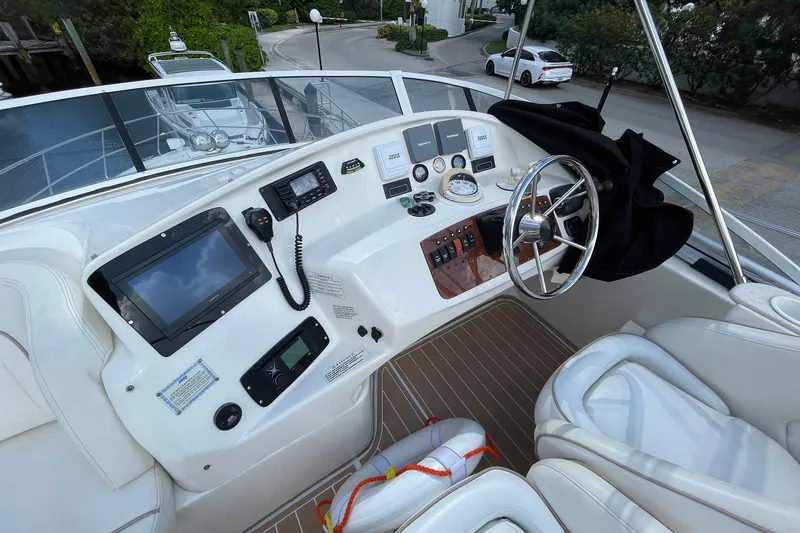  Yacht Photos Pics 2005 Silverton 43 Sport Bridge helm with modern navigation equipment and steering wheel.