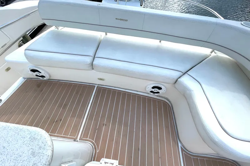  Yacht Photos Pics 2005 Silverton 43 Sport Bridge yacht with white cushioned seating and teak flooring.