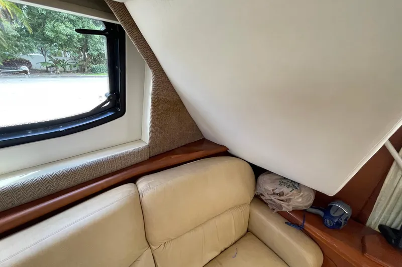  Yacht Photos Pics 2005 Silverton 43 Sport Bridge interior with beige seating and window view.