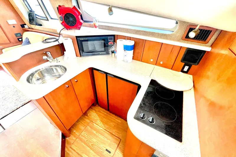  Yacht Photos Pics 2005 Silverton 43 Sport Bridge yacht kitchen with sink, stove, and microwave.