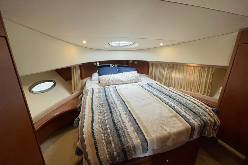  Yacht Photos Pics Luxurious cabin interior of 2005 Silverton 43 Sport Bridge yacht with cozy bedding.