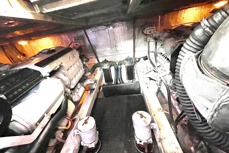  Yacht Photos Pics Engine room of a 2005 Silverton 43 Sport Bridge yacht, showcasing mechanical components.