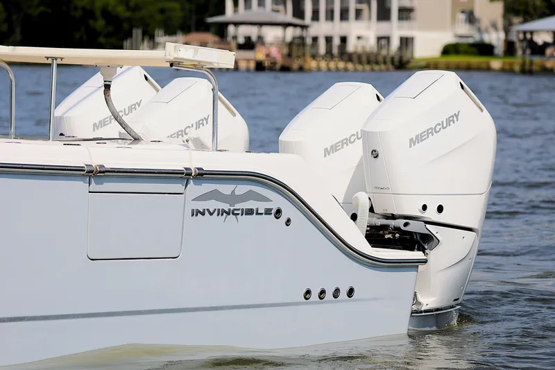  Yacht Photos Pics 2022 Invincible 46 Catamaran with Mercury engines on a calm water backdrop.