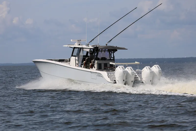  Yacht Photos Pics 2022 Invincible 46 Catamaran cruising on open water, showcasing powerful engines and sleek design.