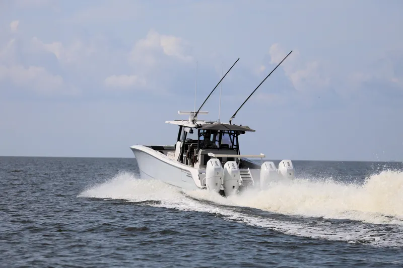  Yacht Photos Pics 2022 Invincible 46 Catamaran cruising on open water with four engines.