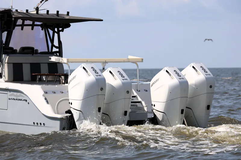  Yacht Photos Pics 2022 Invincible 46 Catamaran with four powerful Mercury outboard engines on the open sea.
