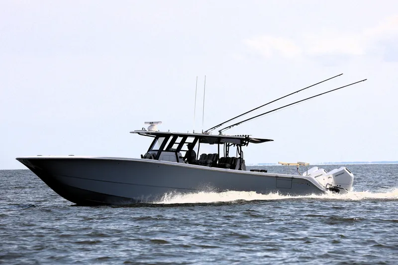  Yacht Photos Pics 2022 Invincible 46 Catamaran cruising on open water, showcasing sleek design and powerful engines.