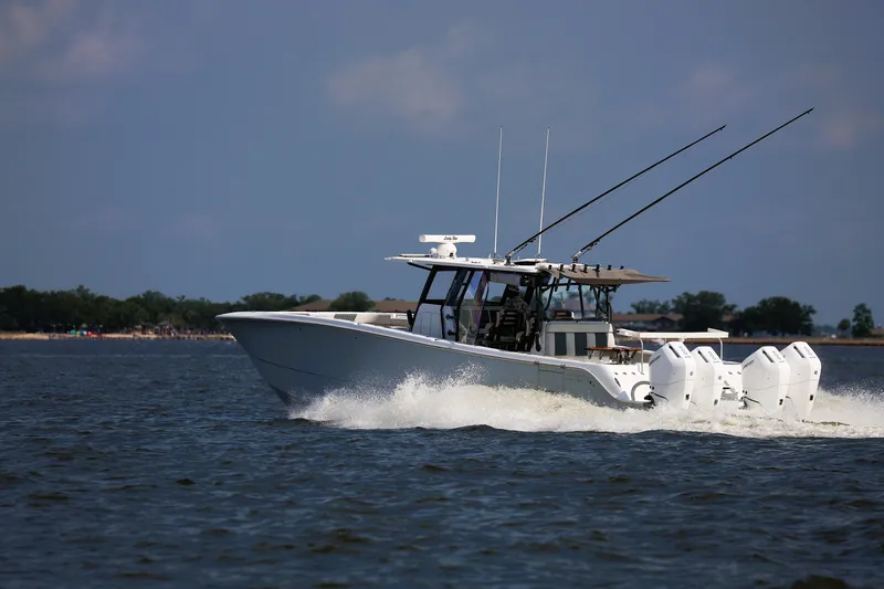  Yacht Photos Pics 2022 Invincible 46 Catamaran cruising on open water with multiple outboard engines.