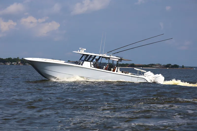  Yacht Photos Pics 2022 Invincible 46 Catamaran cruising on open water under a clear sky.