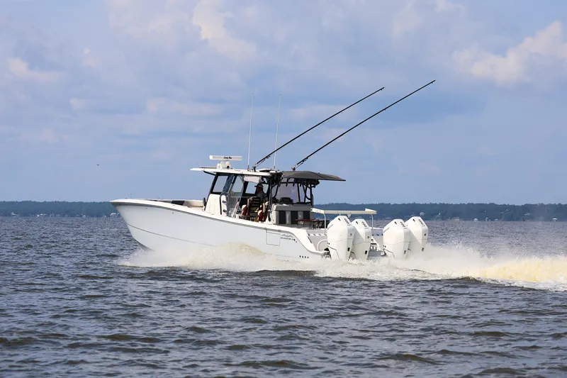  Yacht Photos Pics 2022 Invincible 46 Catamaran cruising on open water under a cloudy sky.