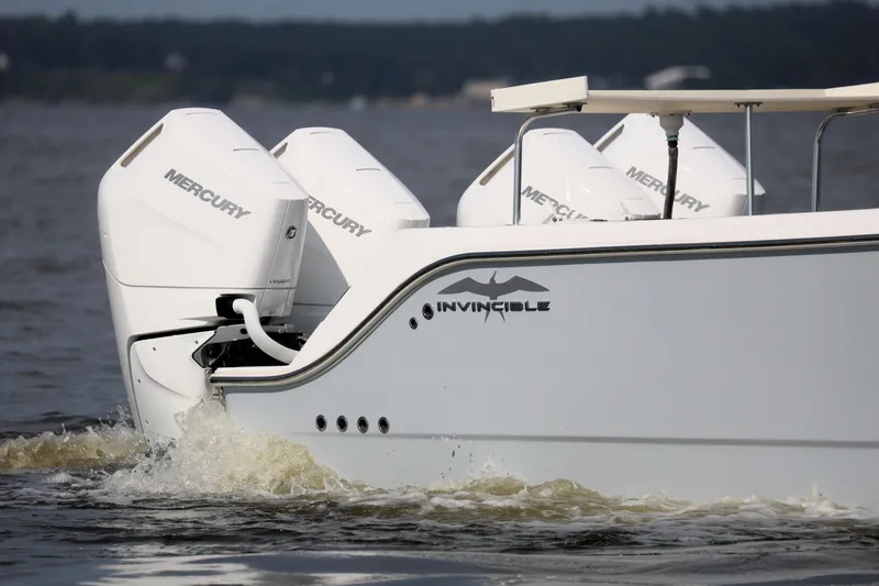  Yacht Photos Pics 2022 Invincible 46 Catamaran with Mercury engines cruising on water.