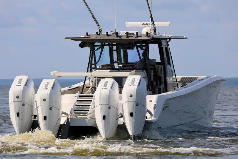  Yacht Photos Pics Invincible 46 Catamaran 2022 with four powerful outboard engines cruising on open water.