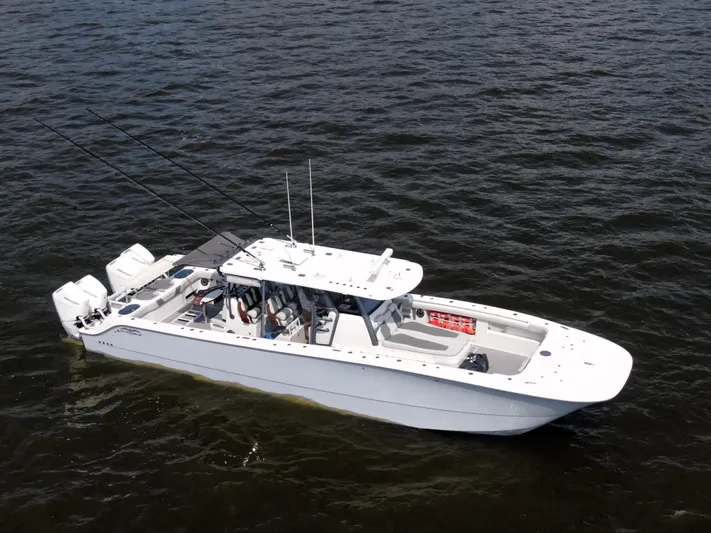  Yacht Photos Pics 2022 Invincible 46 Catamaran on open water, showcasing sleek design and powerful engines.