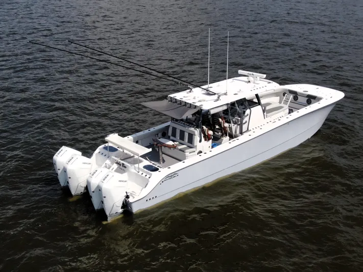  Yacht Photos Pics Invincible 46 Catamaran 2022 on water, featuring multiple outboard engines and spacious deck.