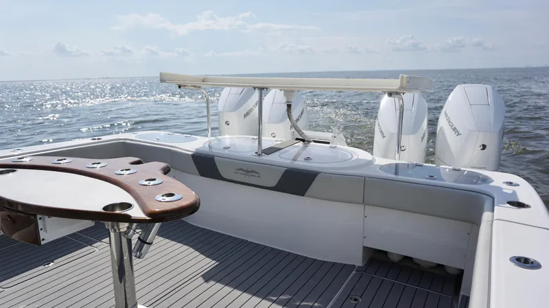  Yacht Photos Pics 2022 Invincible 46 Catamaran with triple Mercury engines on open water.