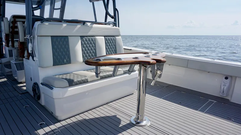  Yacht Photos Pics Luxurious seating and table on 2022 Invincible 46 Catamaran, overlooking the ocean.