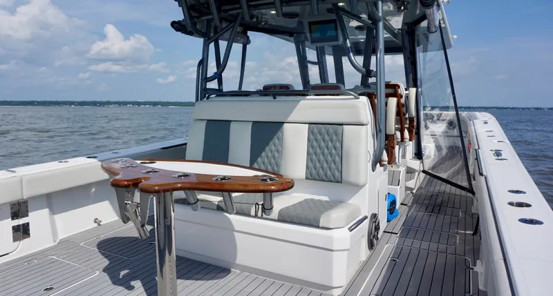  Yacht Photos Pics 2022 Invincible 46 Catamaran with sleek seating and fishing rod holders on open water.