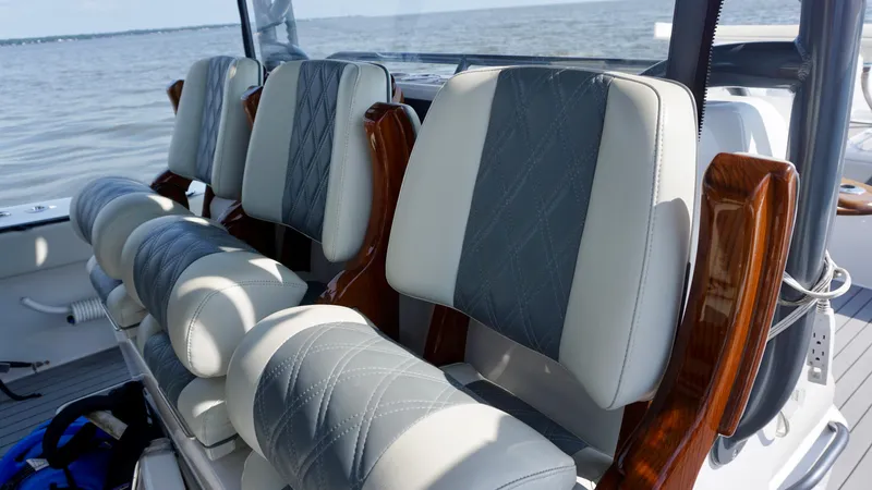  Yacht Photos Pics Luxurious seating on 2022 Invincible 46 Catamaran, featuring elegant design and ocean backdrop.