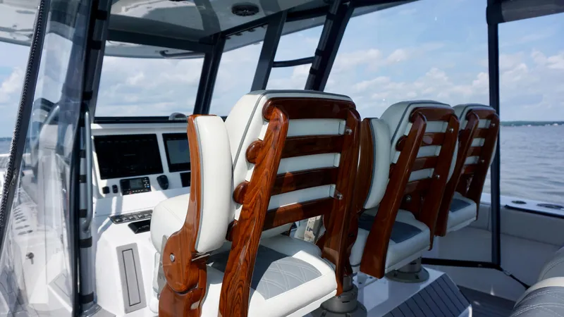  Yacht Photos Pics Luxurious interior of 2022 Invincible 46 Catamaran with elegant wooden seating.