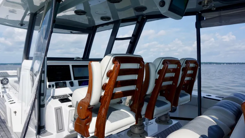  Yacht Photos Pics Interior of 2022 Invincible 46 Catamaran with luxurious seating and advanced navigation equipment.