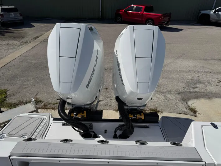  Yacht Photos Pics 2025 Blackfin 332 CC with dual Mercury outboard engines in a parking lot.