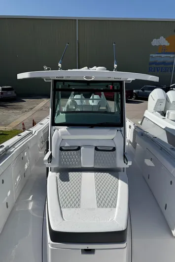  Yacht Photos Pics 2025 Blackfin 332 CC boat, sleek design, white interior, docked outdoors.