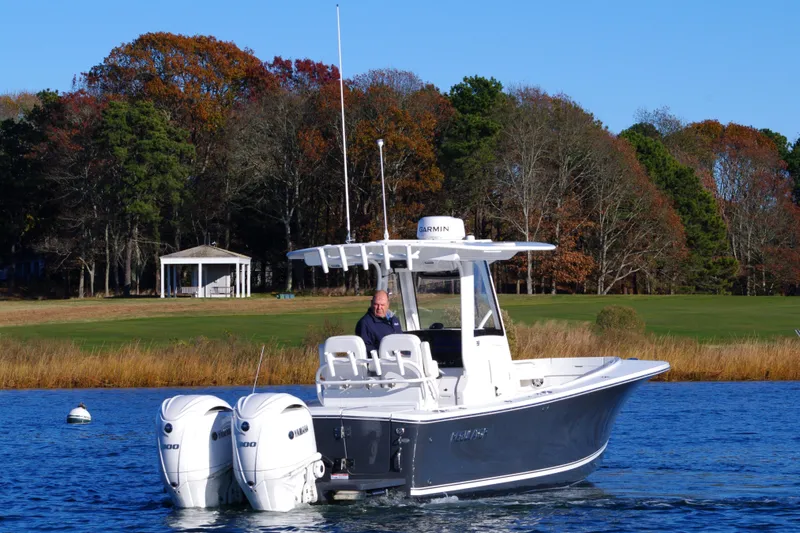  Yacht Photos Pics 2023 Regulator 28 boat with dual engines on a scenic lake.