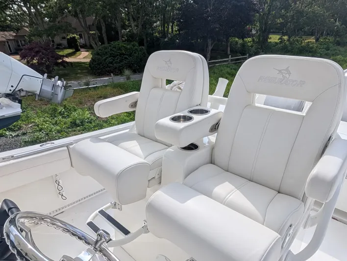  Yacht Photos Pics 2023 Regulator 28 boat with luxurious white seating and cup holders.