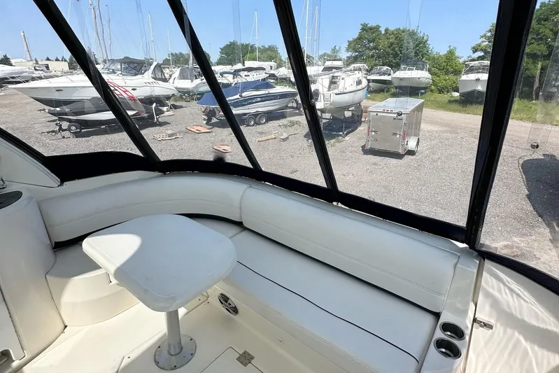  Yacht Photos Pics 2006 Cruisers Yachts 420 Express interior with white seating and table, marina view.