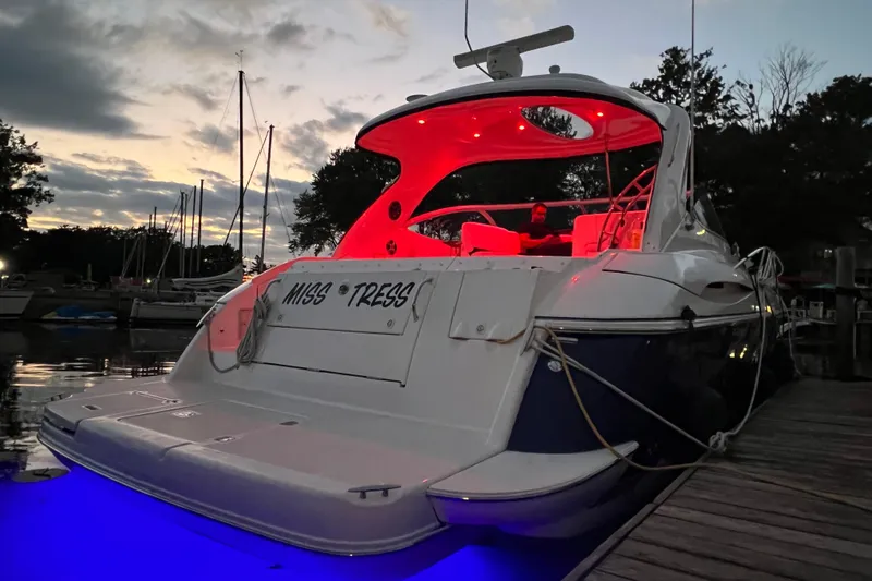  Yacht Photos Pics 2006 Cruisers Yachts 420 Express at dock, illuminated by red and blue lights at sunset.