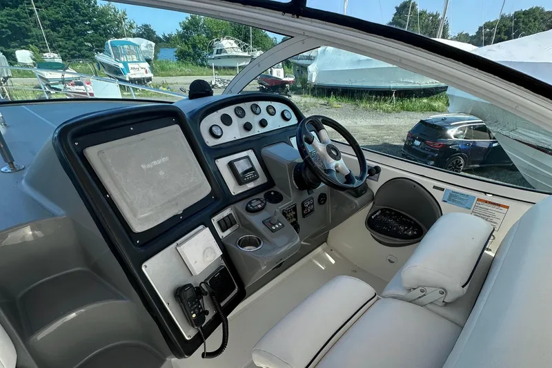 Yacht Photos Pics 2006 Cruisers Yachts 420 Express helm with steering wheel and navigation controls.