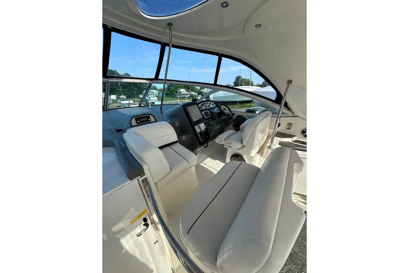  Yacht Photos Pics 2006 Cruisers Yachts 420 Express cockpit with white seating and modern controls.