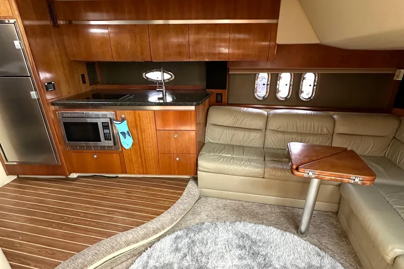  Yacht Photos Pics 2006 Cruisers Yachts 420 Express interior with kitchen, leather seating, and wooden accents.