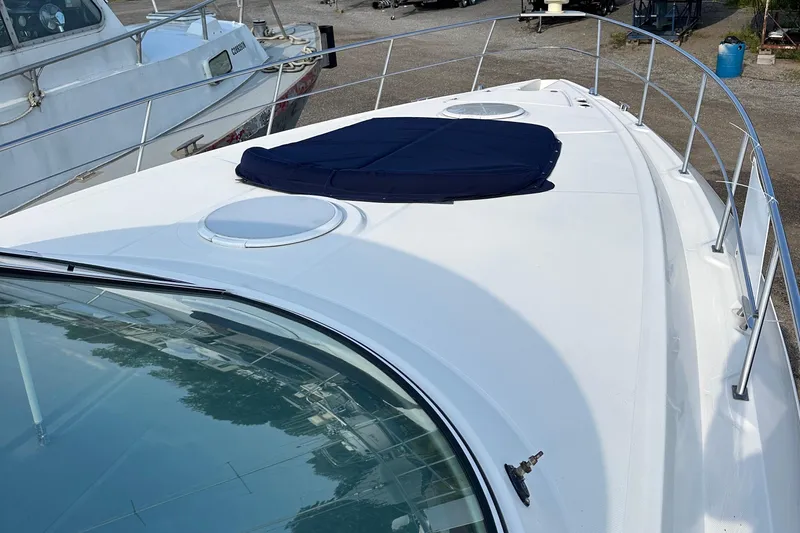  Yacht Photos Pics 2006 Cruisers Yachts 420 Express boat deck with railing and hatch covers.