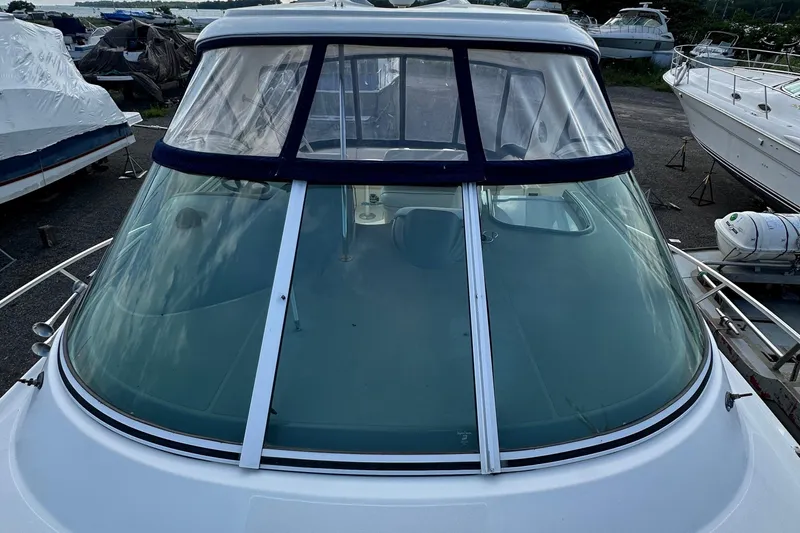  Yacht Photos Pics 2006 Cruisers Yachts 420 Express with clear windshield, docked among other boats.