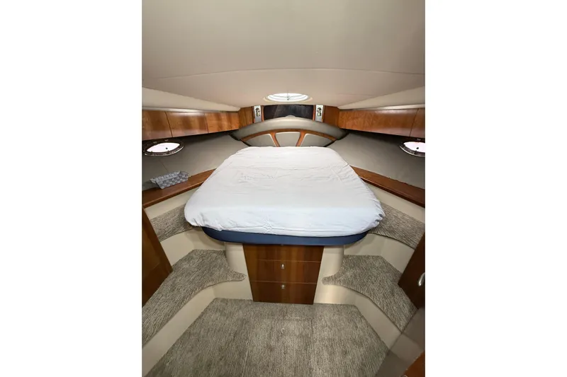  Yacht Photos Pics 2006 Cruisers Yachts 420 Express cabin interior with bed and wooden cabinetry.