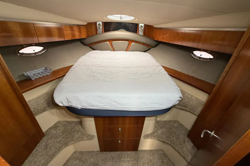  Yacht Photos Pics 2006 Cruisers Yachts 420 Express cabin interior with bed and wooden cabinetry.