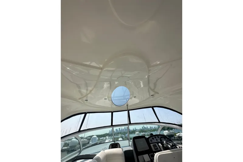  Yacht Photos Pics Interior view of 2006 Cruisers Yachts 420 Express, featuring helm and panoramic windows.