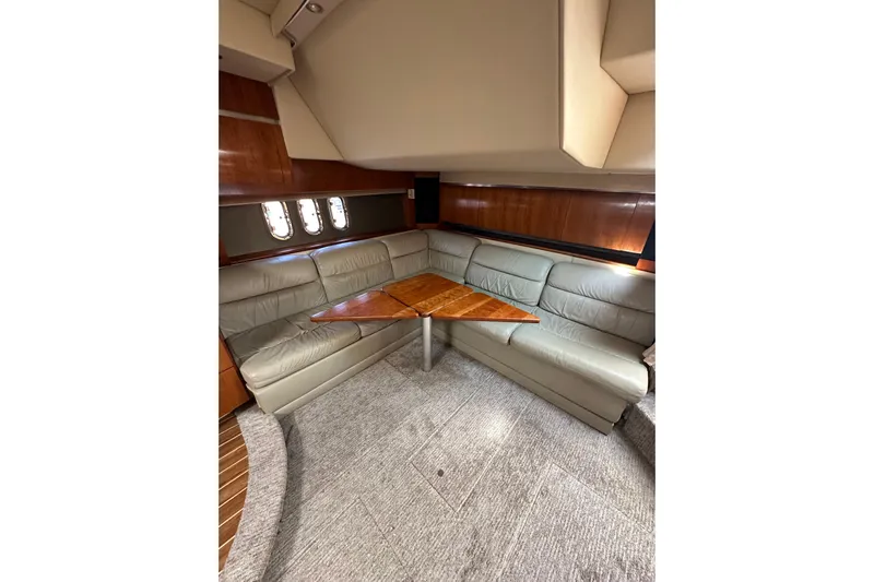  Yacht Photos Pics Luxurious interior of 2006 Cruisers Yachts 420 Express with leather seating and wooden table.