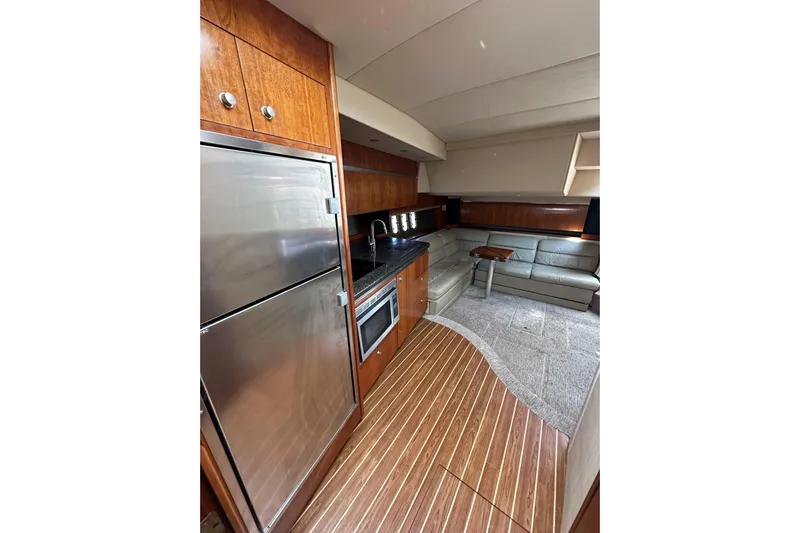  Yacht Photos Pics Luxurious interior of 2006 Cruisers Yachts 420 Express with modern kitchen and seating area.
