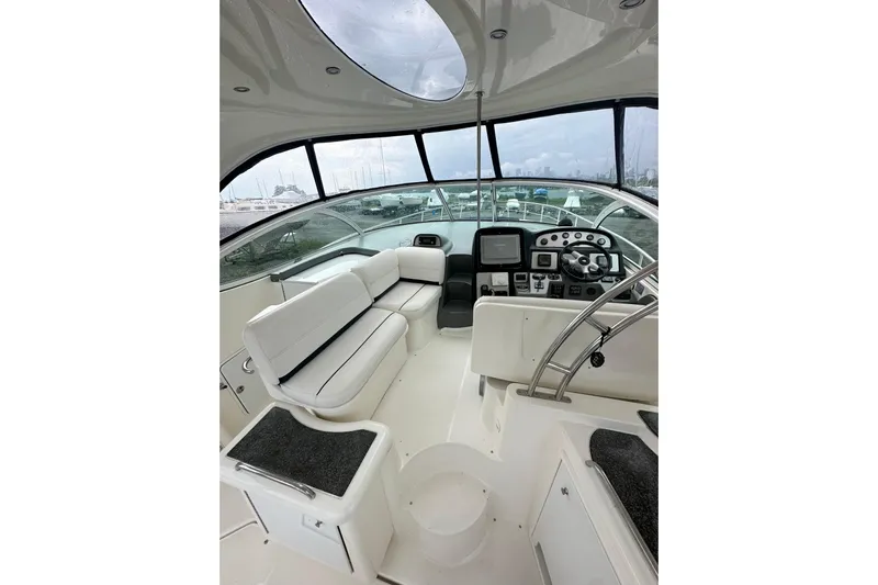  Yacht Photos Pics 2006 Cruisers Yachts 420 Express cockpit with white seating and modern dashboard.