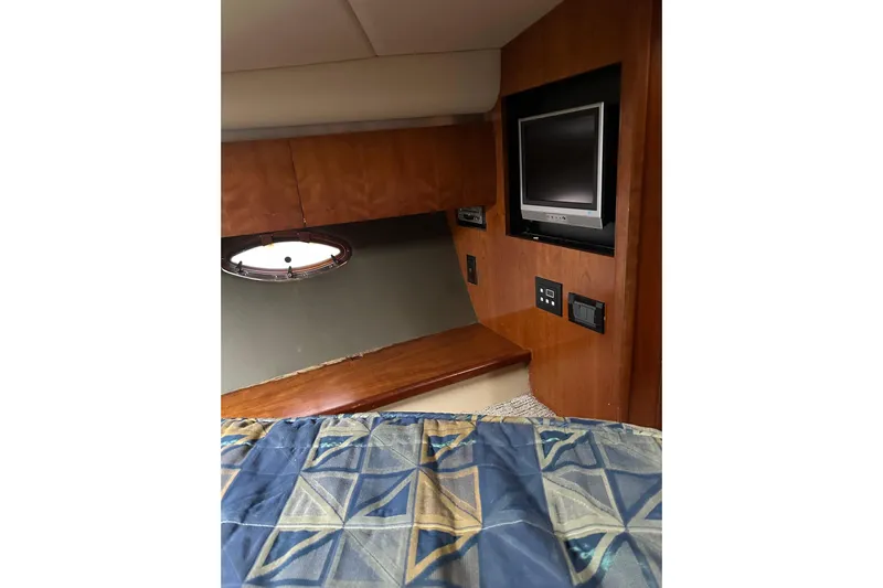  Yacht Photos Pics Interior of 2006 Cruisers Yachts 420 Express with TV and patterned bedding.