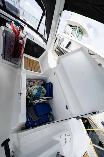 Orion Yacht Photos Pics 2017 Beneteau Oceanis 41.1 sailboat cockpit storage with ropes and equipment.