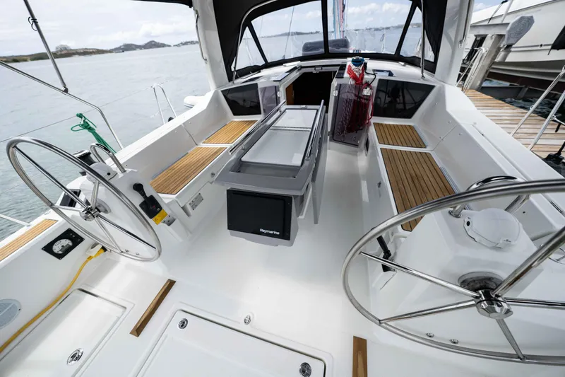 Orion Yacht Photos Pics Cockpit of 2017 Beneteau Oceanis 41.1 sailboat with dual steering wheels and teak seating.
