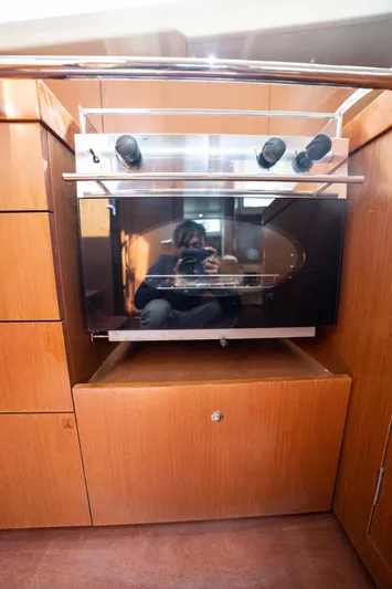 Orion Yacht Photos Pics 2017 Beneteau Oceanis 41.1 yacht kitchen with modern oven and wooden cabinetry.