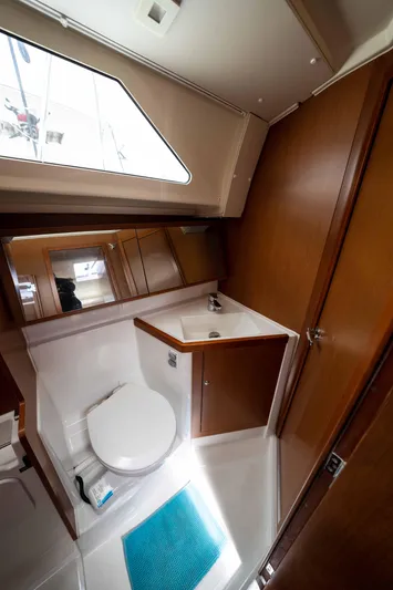 Orion Yacht Photos Pics 2017 Beneteau Oceanis 41.1 yacht bathroom with wooden cabinetry and modern fixtures.