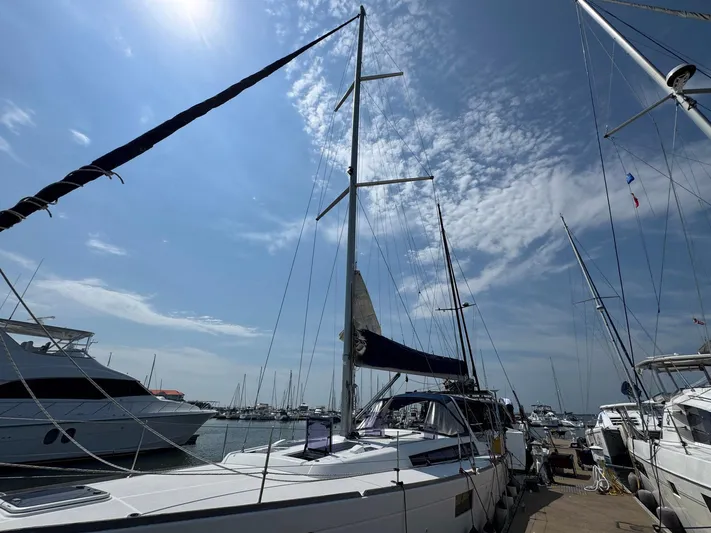 Halcyon Yacht Photos Pics 2017 Beneteau Oceanis 48 sailboat docked under a clear blue sky.