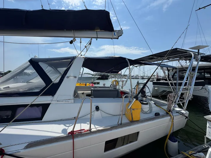 Halcyon Yacht Photos Pics 2017 Beneteau Oceanis 48 sailboat docked at marina under clear blue sky.